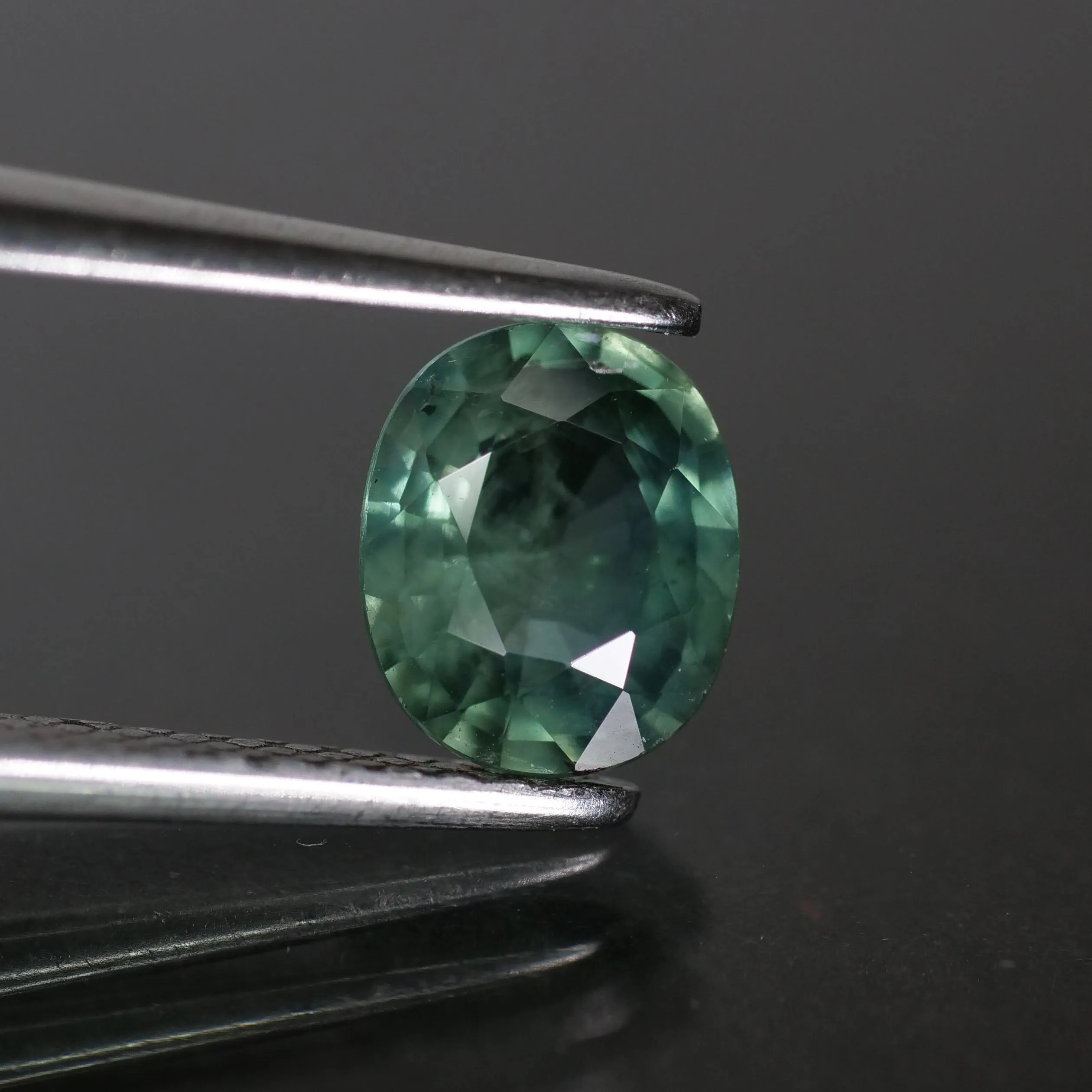 Sapphire | natural, teal (bluish green), oval cut 6.3x5.5 mm, SI, 0.8ct, Madagascar