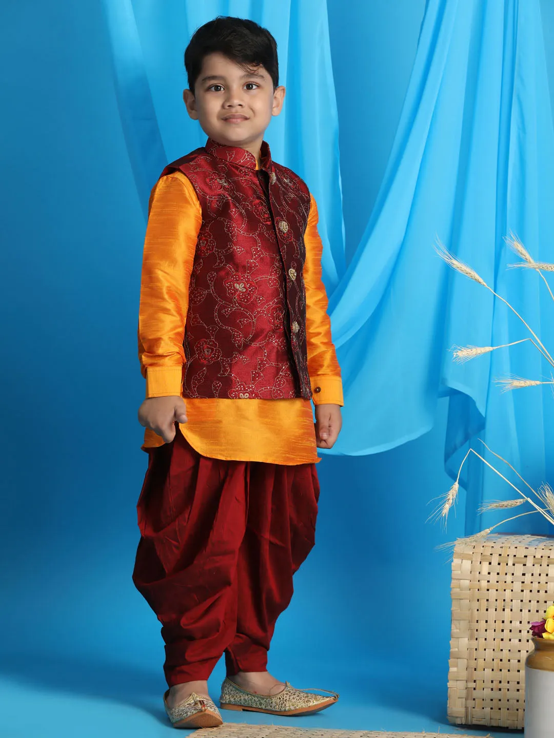 Vastramay Boy's Maroon Embroidered Nehru Jacket With Orange Kurta And Maroon Dhoti Set