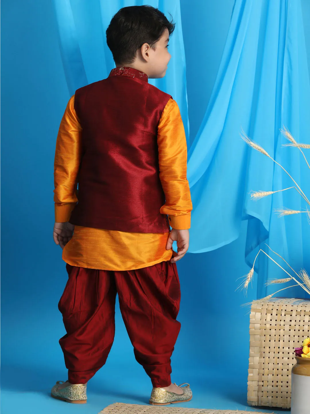 Vastramay Boy's Maroon Embroidered Nehru Jacket With Orange Kurta And Maroon Dhoti Set